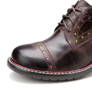 Detailed macro view of brown leather oxford shoes with colorful star cutouts and fine texture