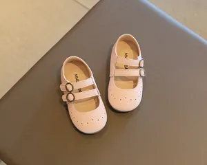 Detail of pink toddler Mary Jane shoes with double buckle straps and brogue patterns.