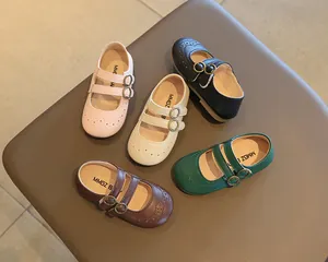 Assorted colors of children's British style Mary Jane leather shoes on a padded display
