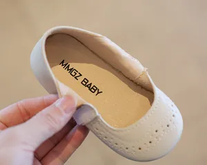 Close-up of girls beige Mary Jane shoes showing soft insole and stitching details