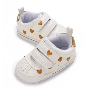 White baby walking shoes with gold heart embroidery and double velcro straps