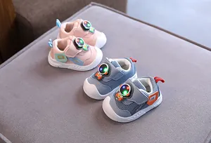 Dettaglio di scarpe da camminata per neonati in mesh rosa e blu con luci a LED.