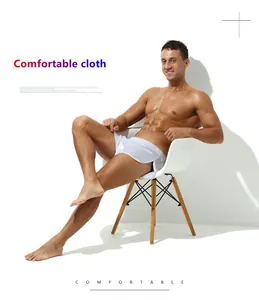 Men's white silky boxer shorts for loungewear or sleep, shown on a male model.