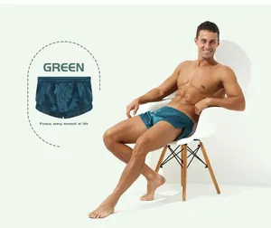 Detailed view of men's silky green boxer shorts featuring a comfortable elastic waistband.