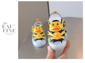 Close-up of cute yellow cartoon duck baby sandals with LED light-up soft soles
