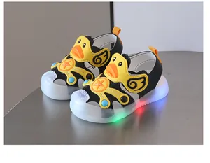 Detailed view of LED light-up toddler sandals with a cute yellow duck design and closed toe