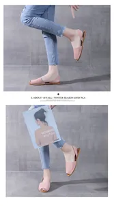 Pink fish mouth flat sandals with backstraps on model against gray background