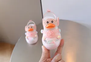 Close-up of pink toddler light-up sandals featuring a cute cartoon duck and star design