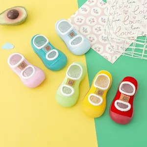 Close-up of colorful non-slip baby walker sock shoes with cute bear tags
