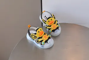 Detail shot of cute yellow duck baby sandals with soft soles and closed-toe design