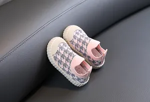 Close-up detail of breathable pink houndstooth mesh sneakers for toddlers and kids.