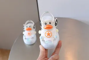 Close-up detail of white baby LED sandals featuring a cute duck and star design for toddlers