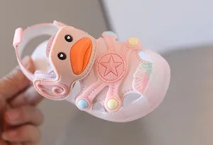 Close-up of pink baby sandal with cute cartoon duck face and light-up star sole details