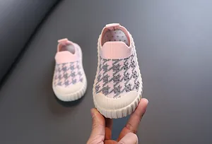 Detail view of pink houndstooth knit pattern on breathable children's slip-on sneaker