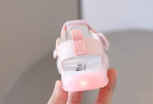 Close-up of the heel of a pink light-up infant walker shoe featuring a soft translucent LED sole