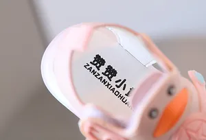 Detailed view of soft-sole pink light-up baby sandal insole with cute cartoon duck detail