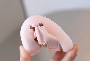 Close-up of flexible soft sole pink baby sandal showing toddler shoe durability