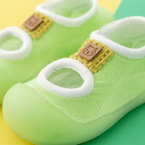 Close-up of lime green baby walking socks with non-slip soft rubber soles.