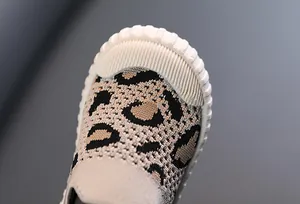 Close-up of leopard print baby walking shoe with protective white ribbed toe cap