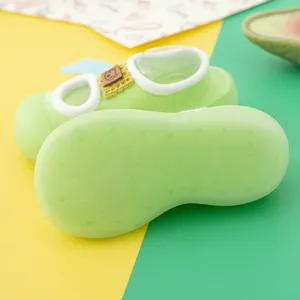 Close-up of breathable non-slip soft sole on light green baby walking shoe socks