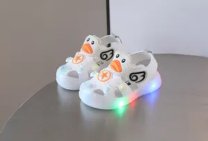 Cute white LED light-up baby sandals with soft soles and cartoon duck design for toddlers