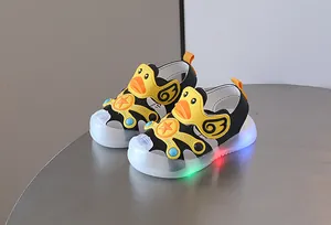 Detailed view of LED light-up toddler sandals featuring a cute yellow cartoon duck design