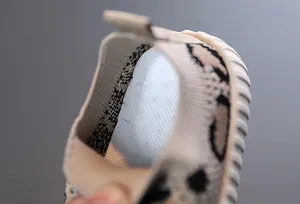Detail of breathable mesh insole and leopard knit collar on toddler walking shoe.
