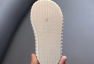 Close-up of the non-slip rubber sole with wave pattern for infant walking shoes, size 23.