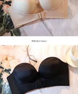 Strapless front-buckle push-up bras in skin color and black displayed on white fur.