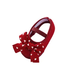 Red soft-sole baby princess shoes featuring a large heart-patterned bow ornament