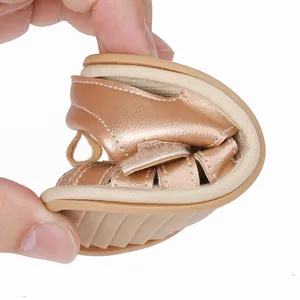Detail showing the ultra-flexible soft sole of these rose gold baby sandals