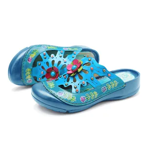 Gros plan sur des chaussures vintage en cuir bleu avec fleurs et perles artisanales