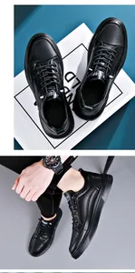 Detailed view of men's black casual leather sneakers with white tongue text
