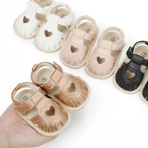 Close-up showing various colors of heart-pattern infant summer sandals with soft soles
