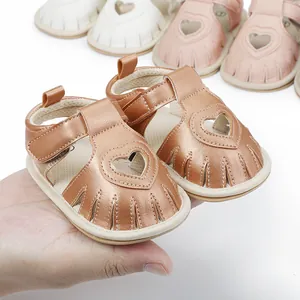 Close-up detail of rose gold baby heart sandals featuring a breathable hollow design.