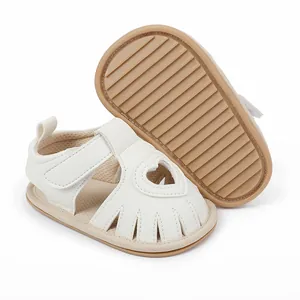 Comfortable white baby sandals with heart cutout and anti-slip rubber sole for toddlers