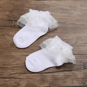 Detailed view of white baby lace ruffle socks with delicate mesh trim