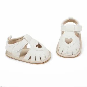 Detailed view of white baby heart sandals with velcro straps for summer