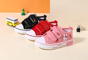 Detailed view of colorful children's canvas shoes with cute rabbit and carrot patterns