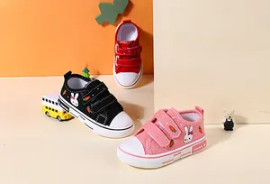 Close-up of colorful children's canvas shoes featuring cute bunny and carrot patterns