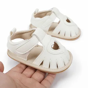 Detailed view of off-white summer baby sandals featuring a heart-shaped cutout design
