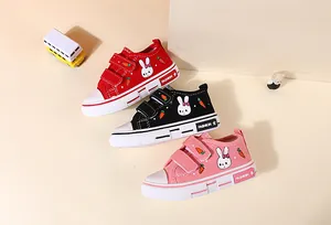 Detailed view showing three colors of children's rabbit-print canvas sneakers.