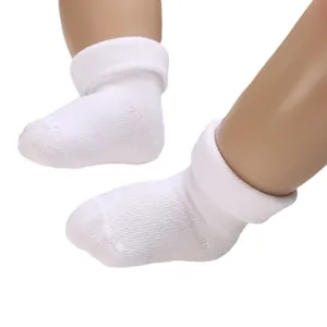 Soft white knitted cotton baby socks with rolled cuffs for infants and toddlers aged 0-2