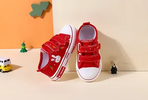 Red children's canvas shoes with cute rabbit and carrot patterns and velcro straps