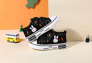 Detail shot of cute black children's canvas shoes with rabbit and carrot prints