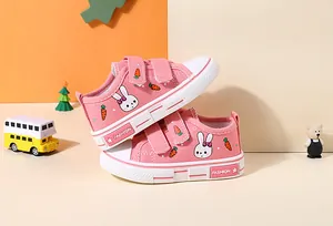 Side view detail of pink children's canvas sneakers with cute bunny and carrot prints