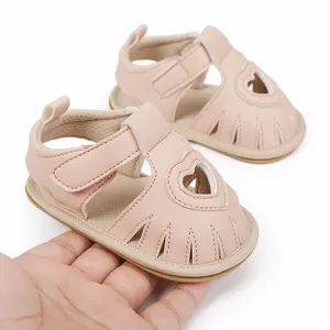 Detailed view of soft pink baby sandals featuring a cute heart cutout and secure strap.