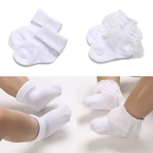 Detailed view of white lace fold-over infant socks for babies aged 0 to 1 year.