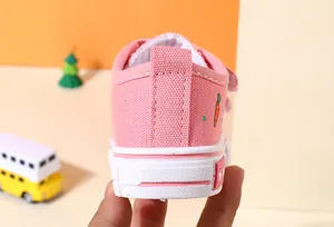 Detailed view of pink children's canvas shoe heel featuring a cute carrot embroidery