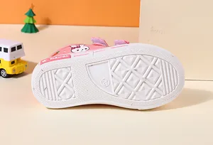 Detailed view of white rubber sole on pink kids canvas sneaker with geometric pattern